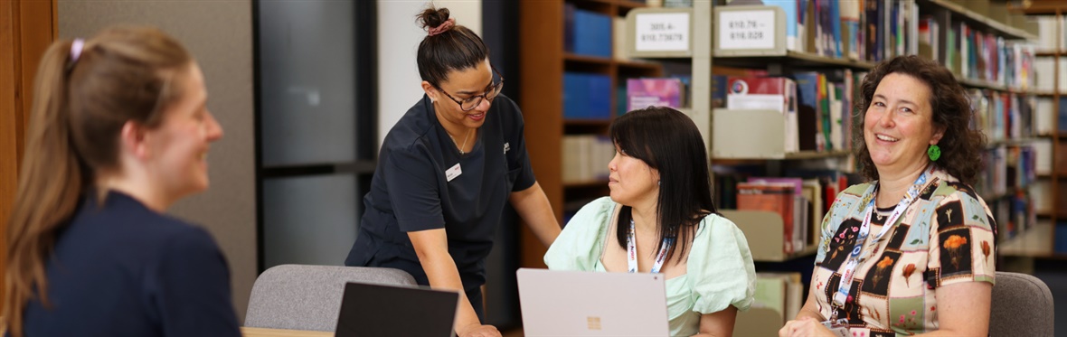 #caption104718 People sitting in the Austin Library bookroom
